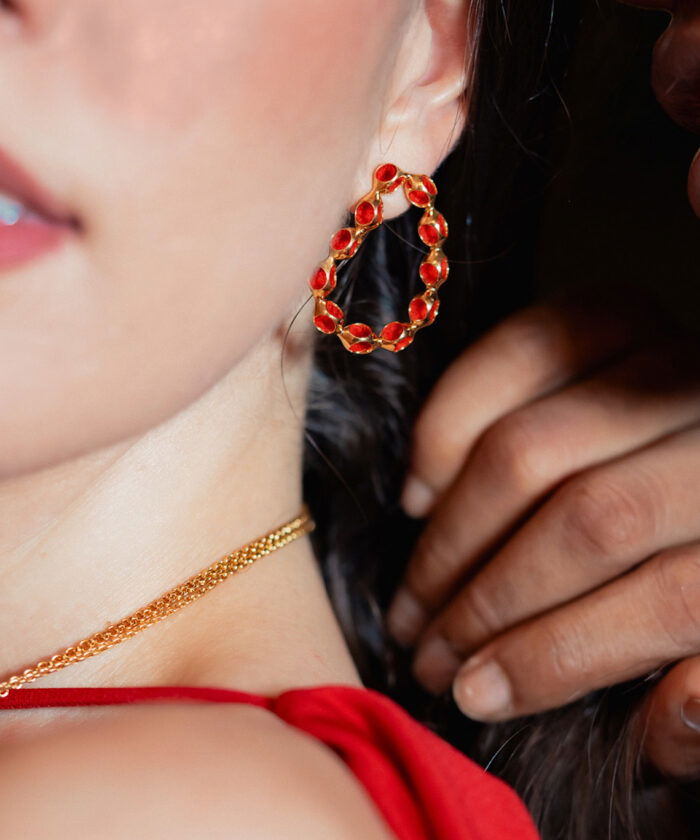 Bold red hoop earrings with gold accents, stylish jewelry for women’s fashion.