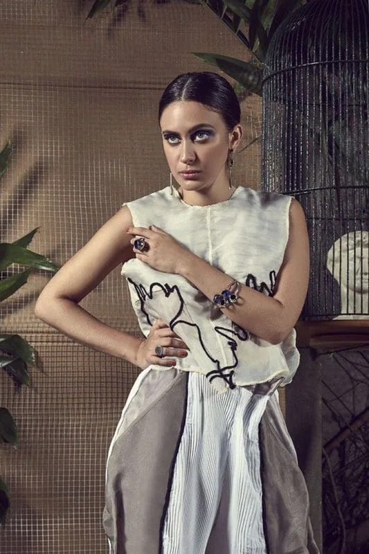 Elegant woman wearing high fashion outfit, sophisticated jewelry, stylish pose.