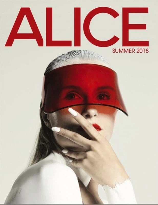 Elegant Monica Varela with reflective red visor mask showing high fashion style.