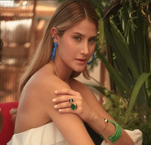 Stylish Monica Varela showcasing trendy accessories at Miami Fashion Week.