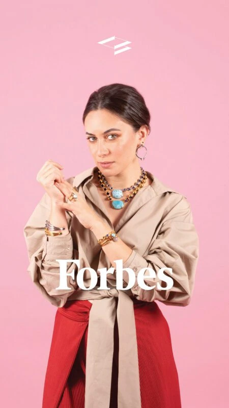 Stylish woman wearing colorful necklaces and rings for Forbes Mexico feature.