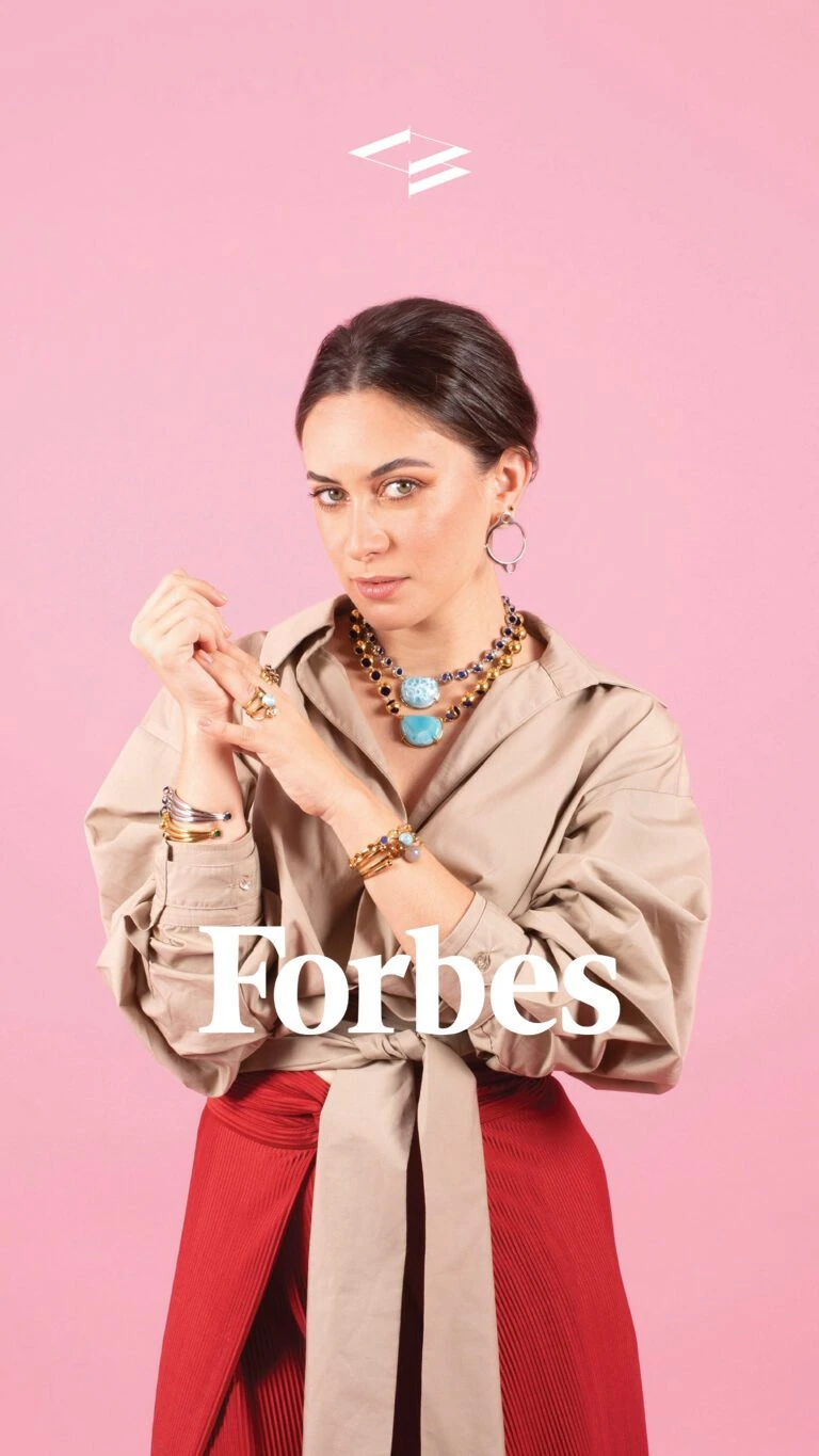 Stylish woman wearing colorful necklaces and rings for Forbes Mexico feature.