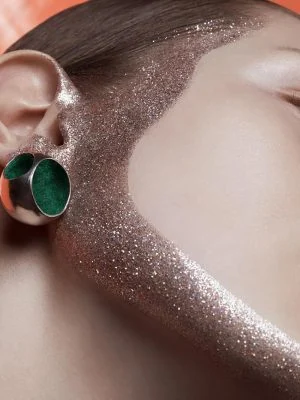 Close-up of glitter and makeup on face for editorial photoshoot.