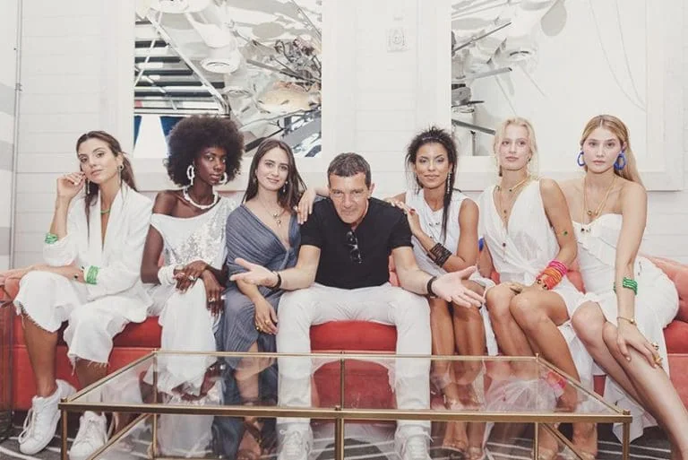 Stylish models with designer outfits at Miami Fashion Week event.