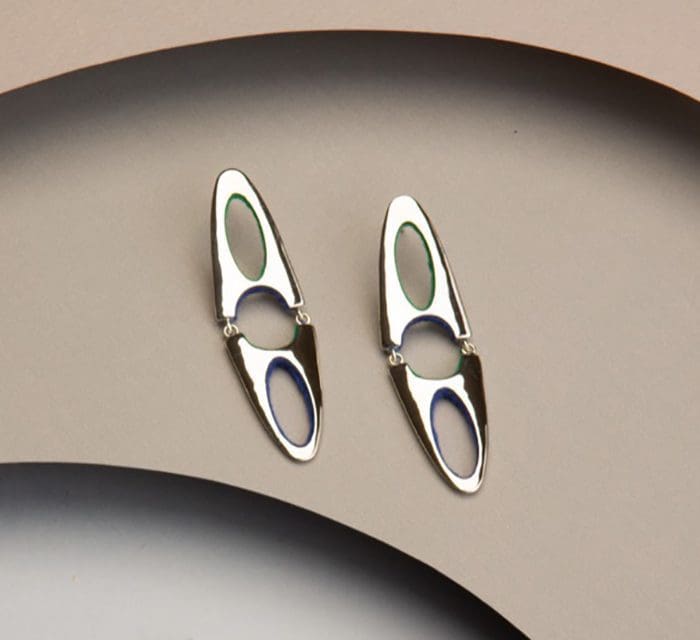 Elegant silver modern earrings with open oval design for stylish fashion statements.