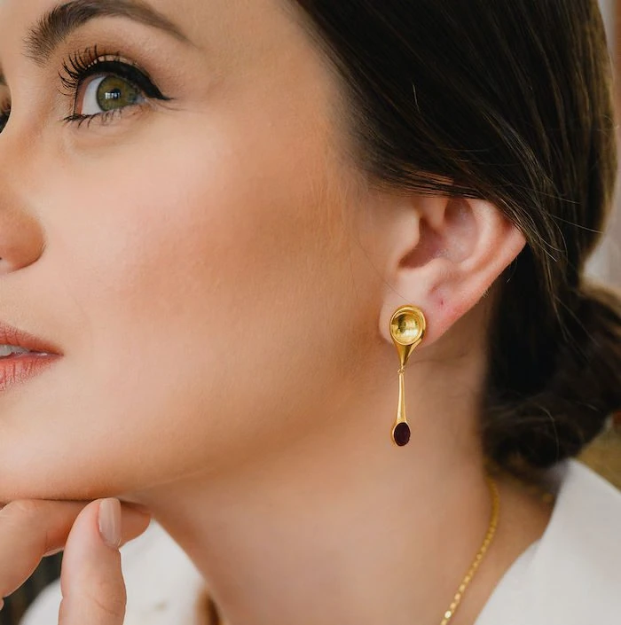 Gold drop earrings with a teardrop design, perfect for stylish and sophisticated looks.