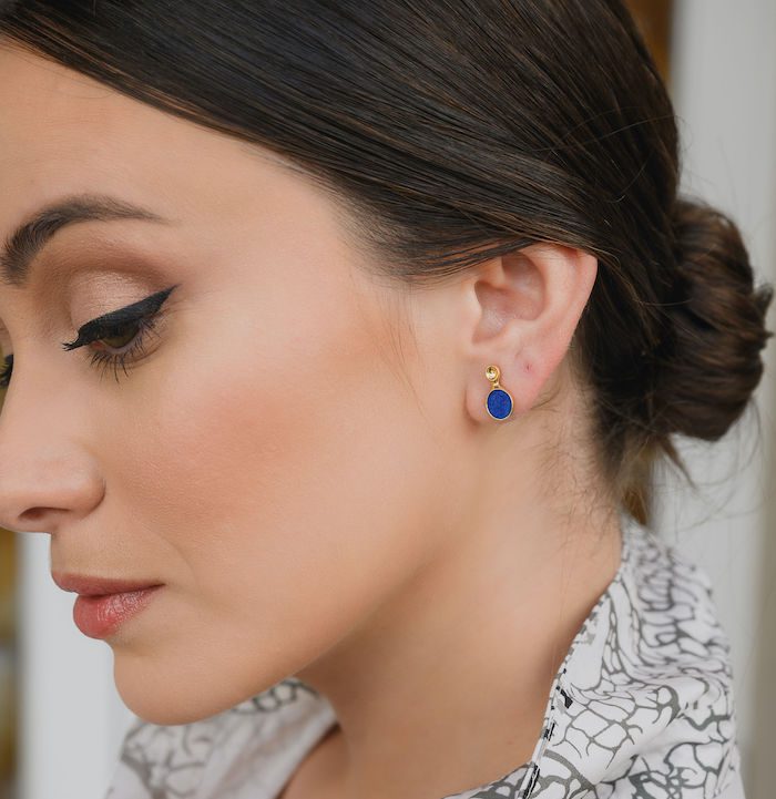 Blue gemstone stud earrings for women, stylish jewelry accessory.