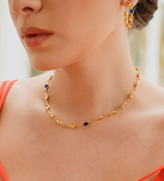 Gold necklace with blue accents perfect for stylish accessories.