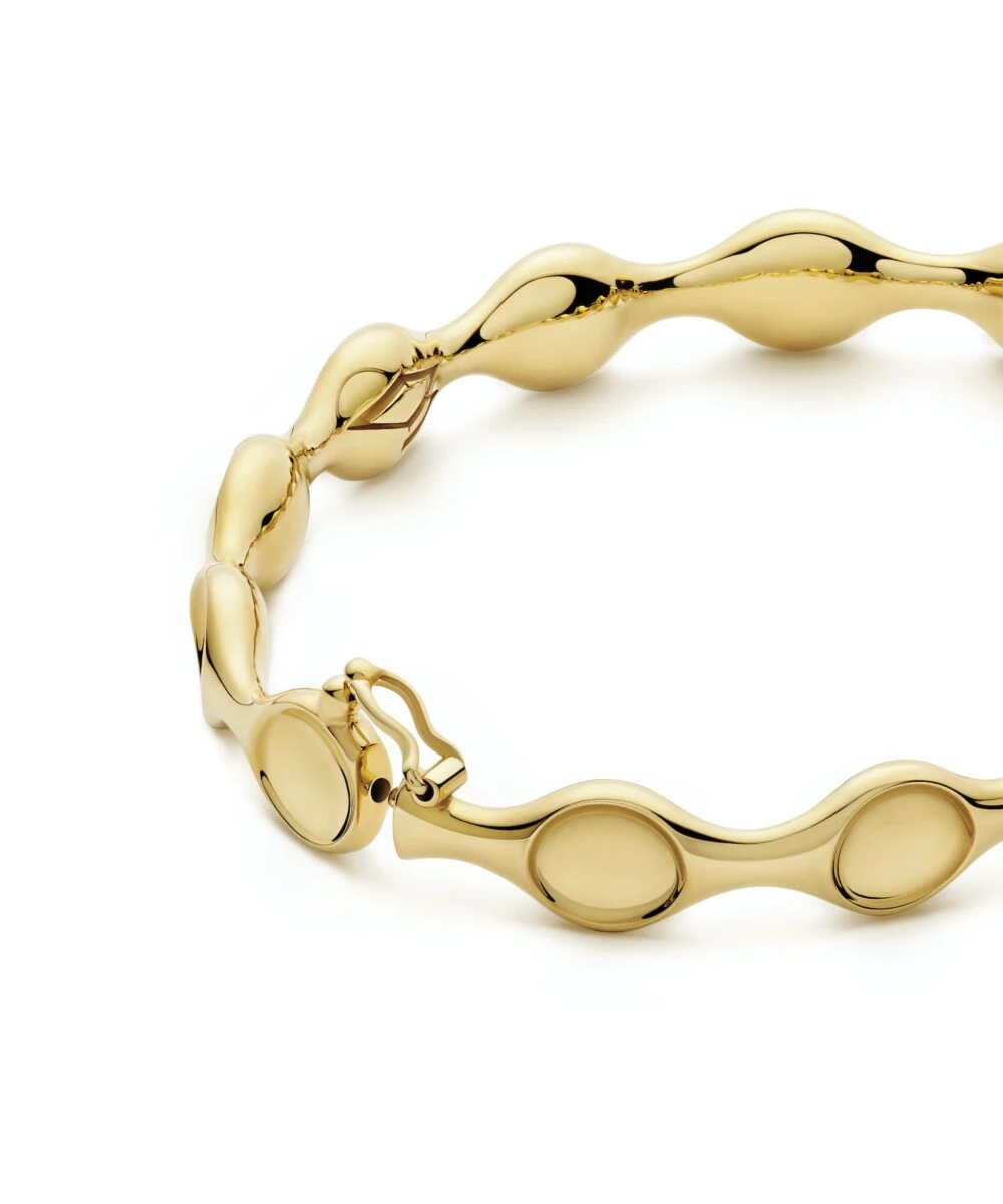 Shiny gold margin bangle bracelet with smooth, rounded edges, perfect for luxury accessory style.