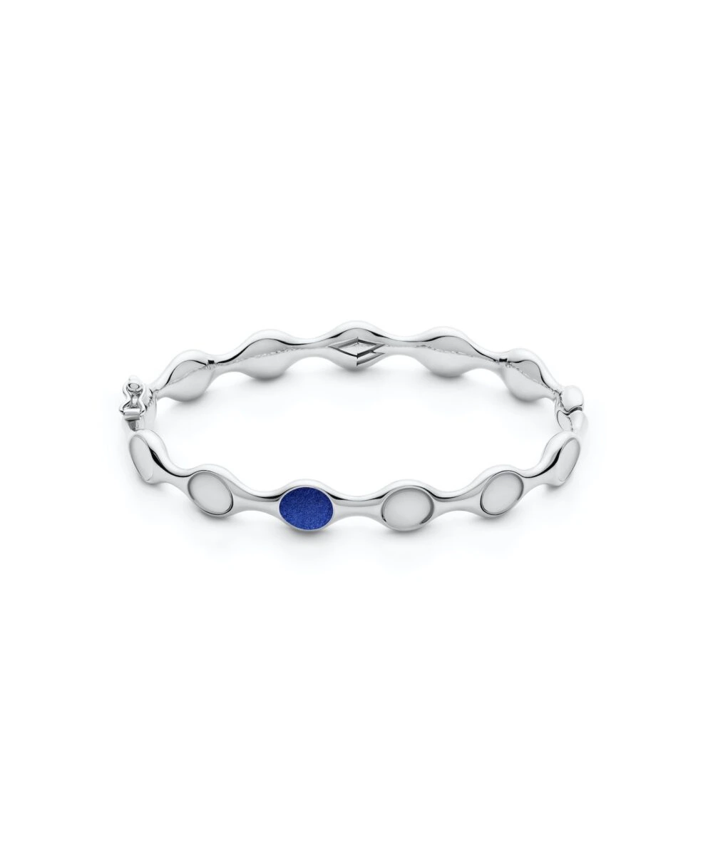 Stylish fashion bangle featuring a sleek silver design with circular blue gemstone accents.