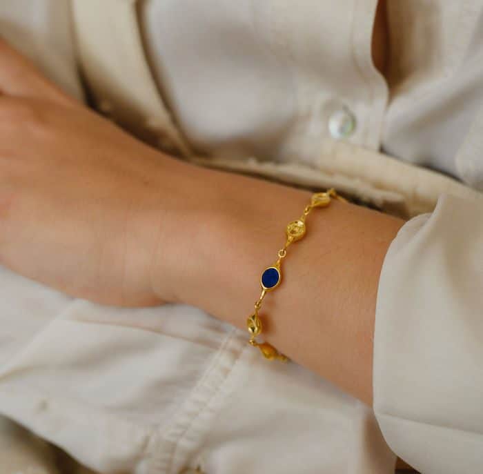 Elegant gold bracelet with blue accents, perfect for stacking or everyday wear.
