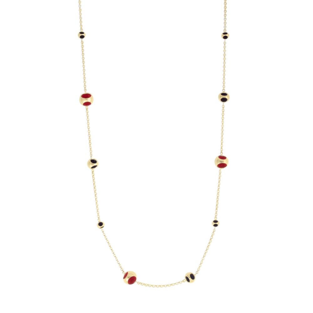 Delight in this gold-tone necklace featuring red and black beads, perfect for sophisticated style.