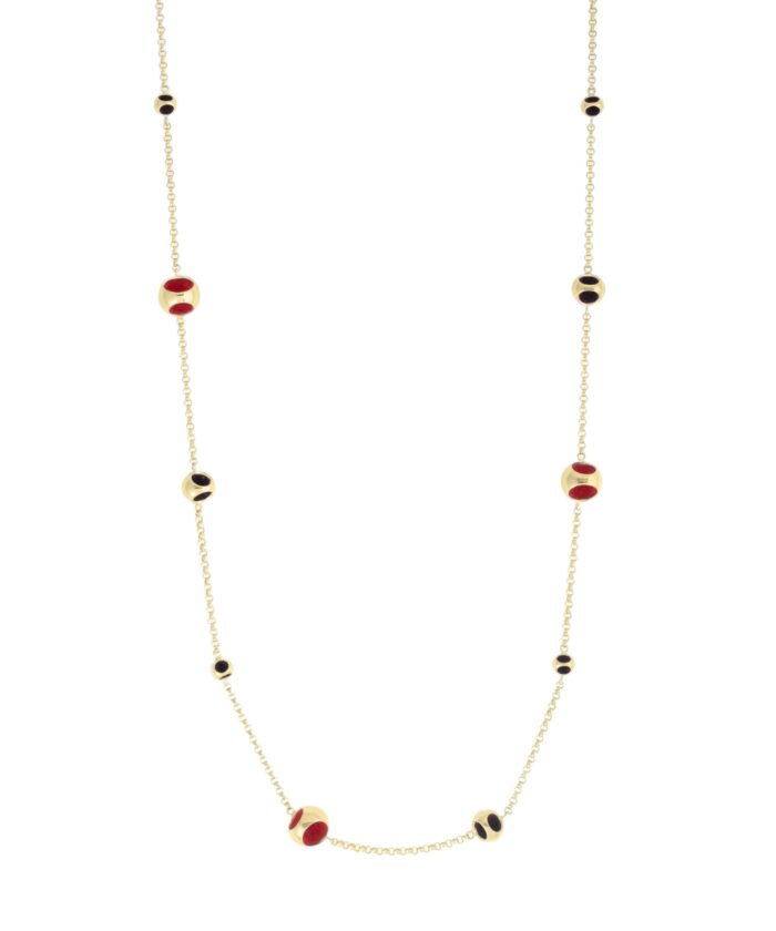 Delight in this gold-tone necklace featuring red and black beads, perfect for sophisticated style.