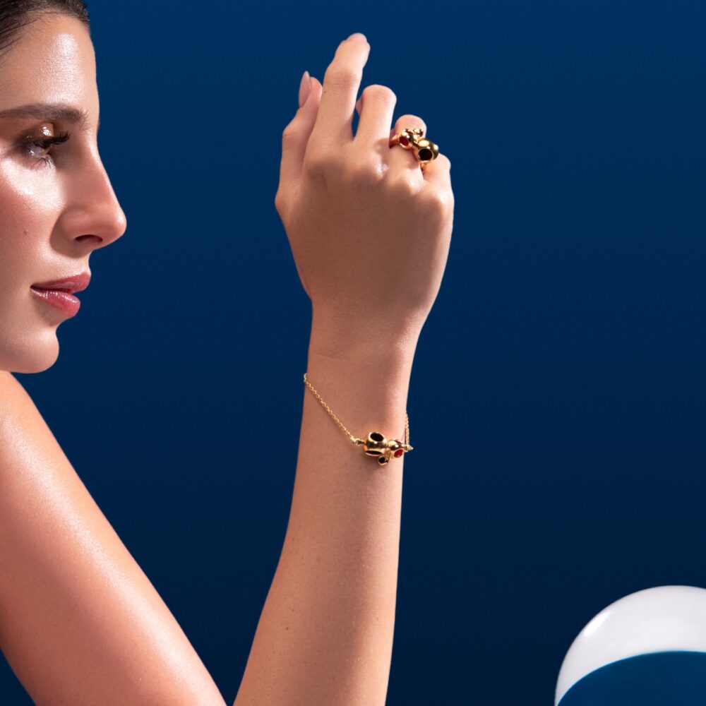 Luxury gold jewelry featuring black and red stones, designed by Monica Varela.