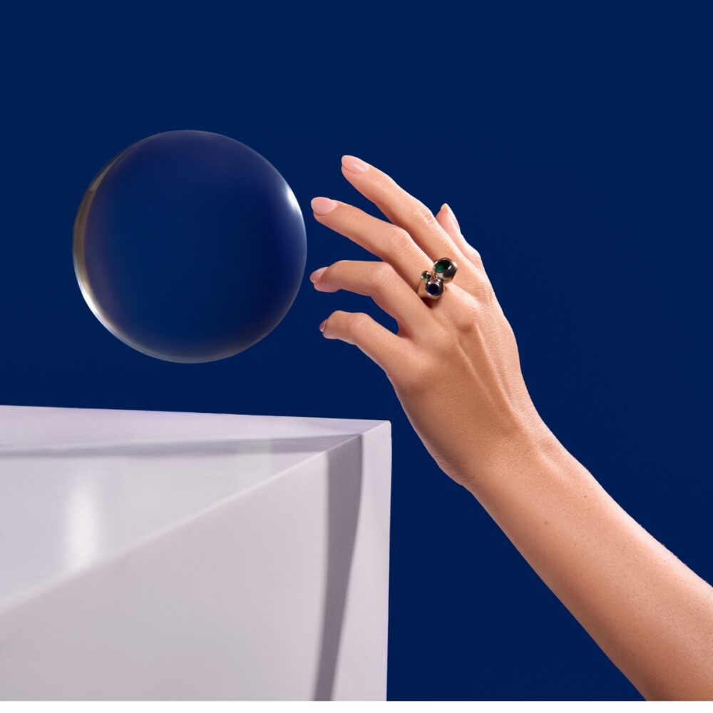 Luxurious jewelry featuring Monaca Varela ring with dark and green gemstones.