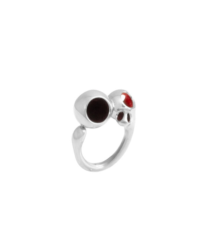 Sterling silver ring featuring a skull design with black and red enamel accents. Unique jewelry piece with gothic style.