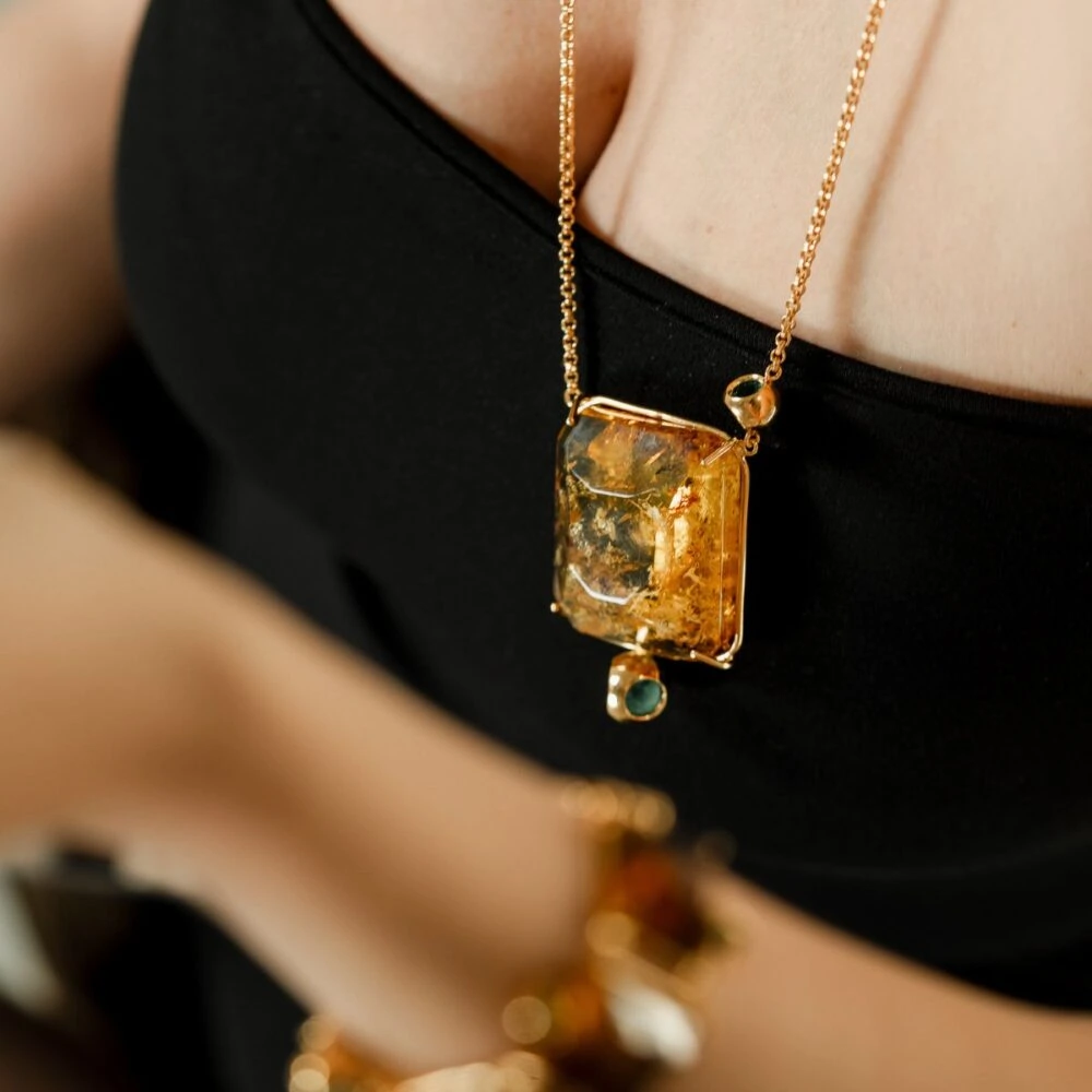 Luxurious Larimar pendant necklace featuring gold chain and gemstone details for sophisticated jewelry styles.