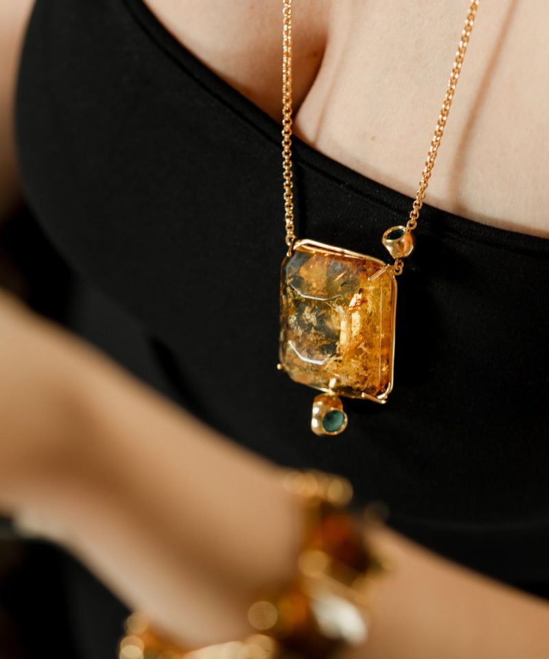 Duet Amber Necklace in 925 sterling silver with 18k gold plating and Blazing Burgundy accents, worn by model
