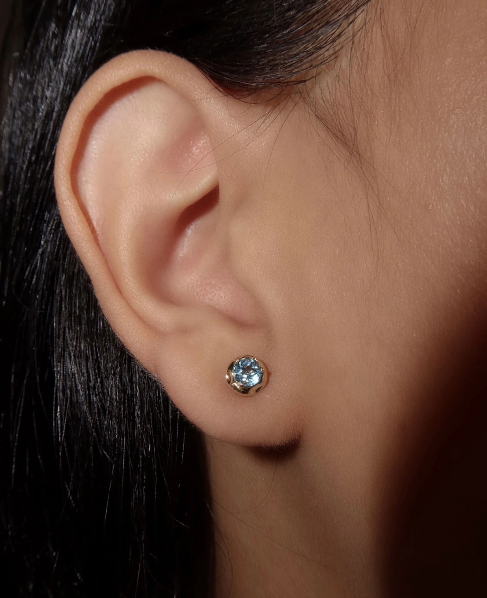 Whisper Blue Topaz Studs - Elegant jewelry featuring blue topaz gemstone earrings for women. Small blue topaz stud earrings in a sleek gold setting, perfect for everyday wear and special occasions.