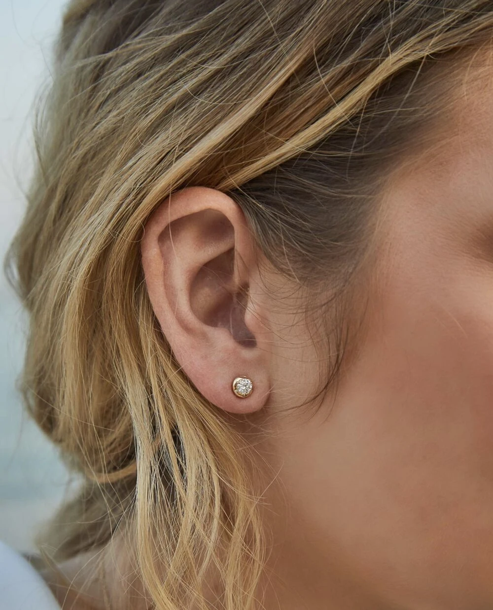 Sparkling diamond stud earrings enhancing feminine style and elegance.