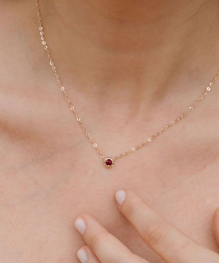 Elegant ruby pendant necklace with delicate gold chain for sophisticated style.