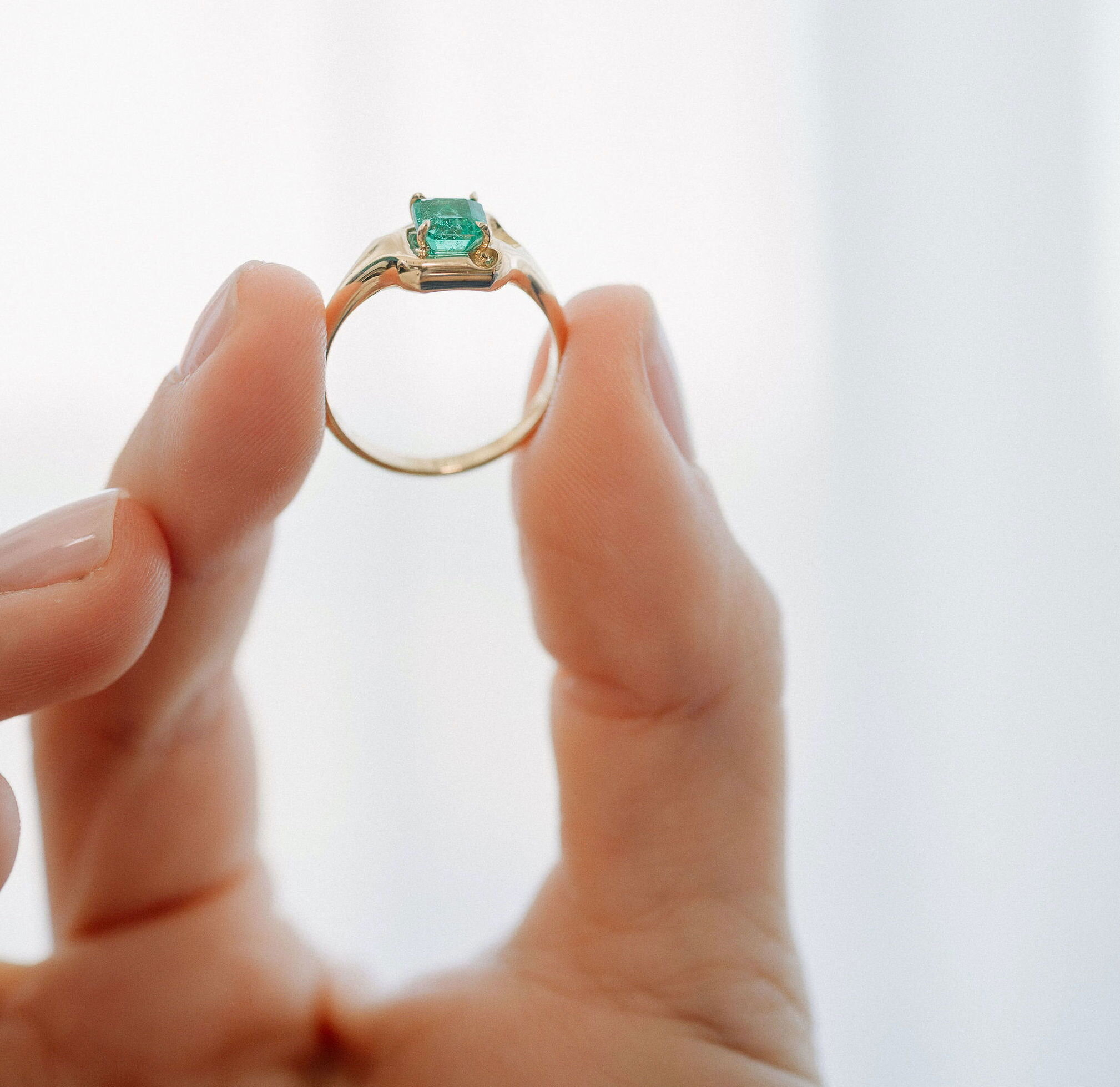 Emerald Cut Ring Elegant gold ring with a stunning emerald-cut gemstone.