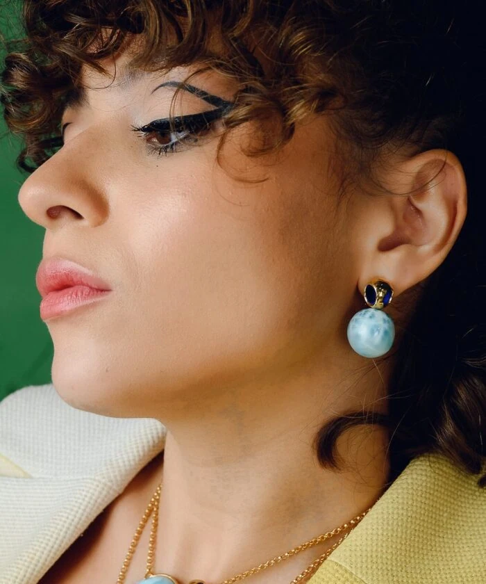 Dainty Larimar gemstone studs with gold accents, perfect for sophisticated jewelry looks.