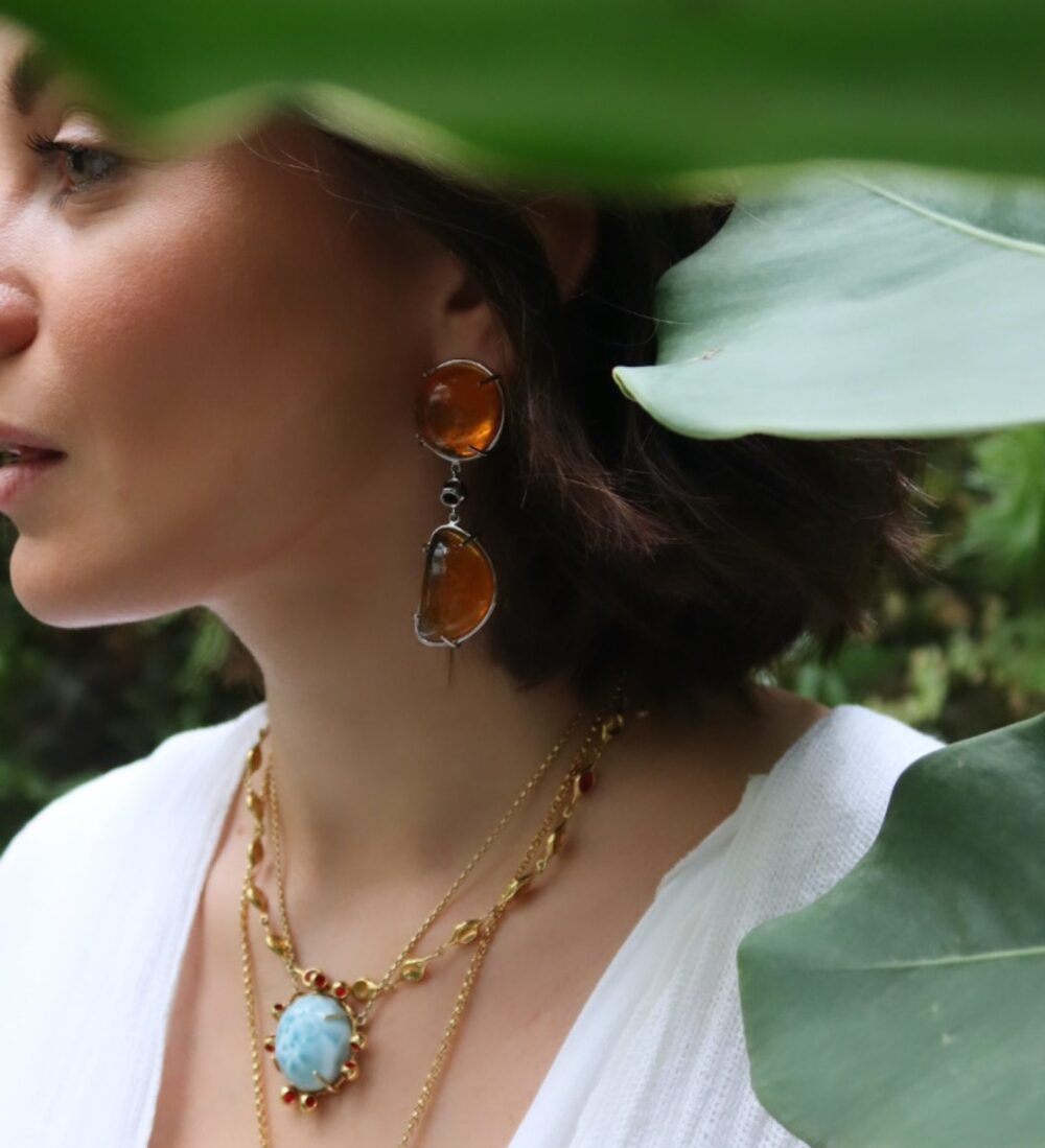 Artisan amber earrings featuring striking orange stones with silver details.