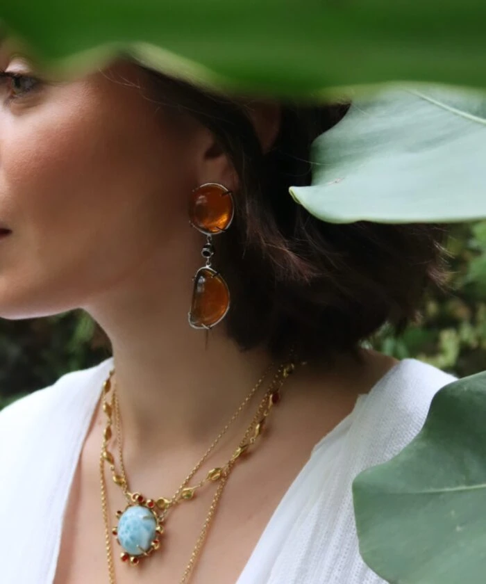 Artisan amber earrings featuring striking orange stones with silver details.