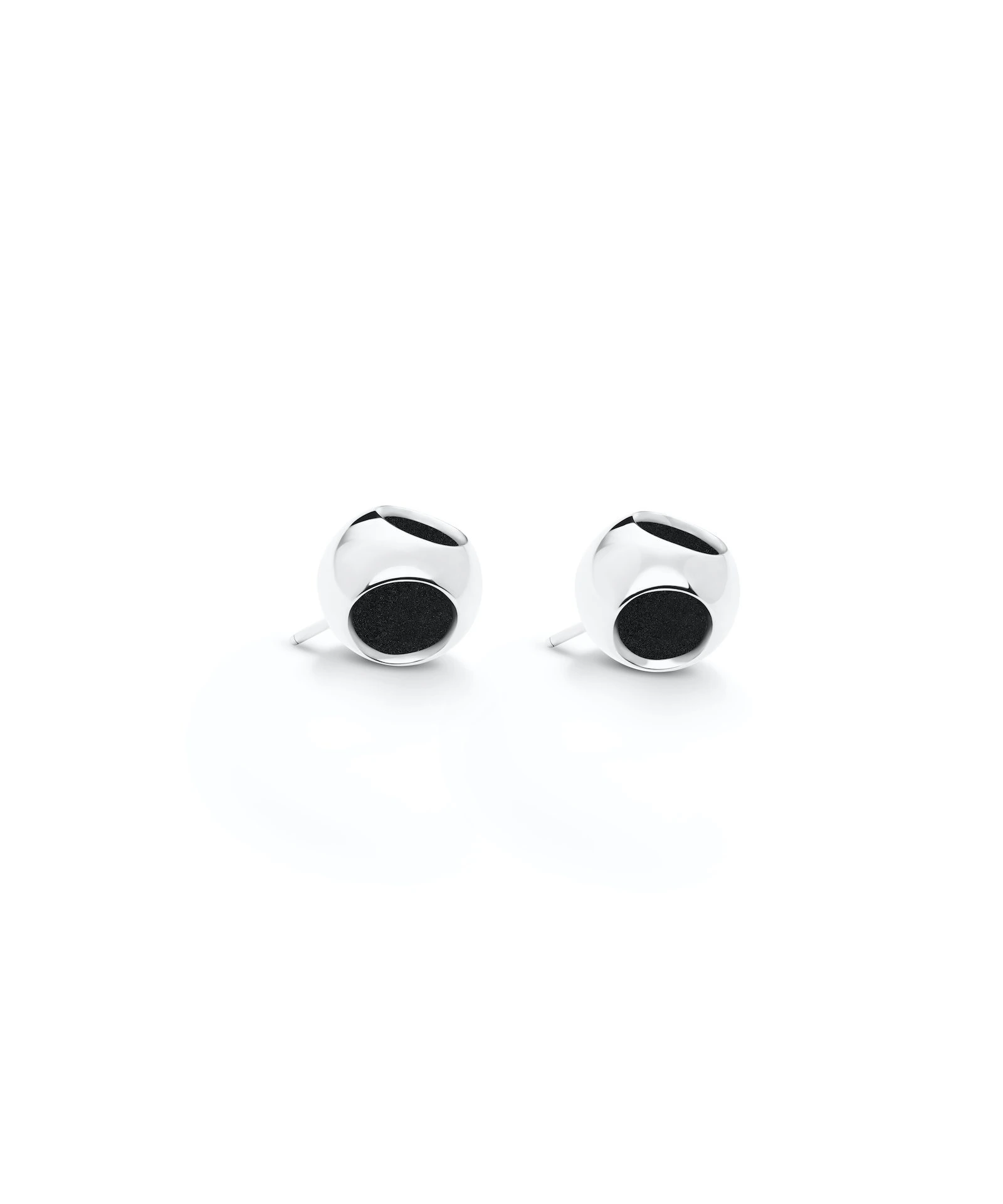 Modern silver stud earrings with black accents Sleek silver stud earrings with black circular details, perfect for elegant and casual styles.