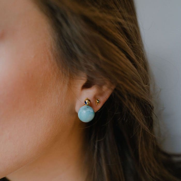 Beautiful Larimar stud earrings with gold accents, perfect for elegant jewelry collection.