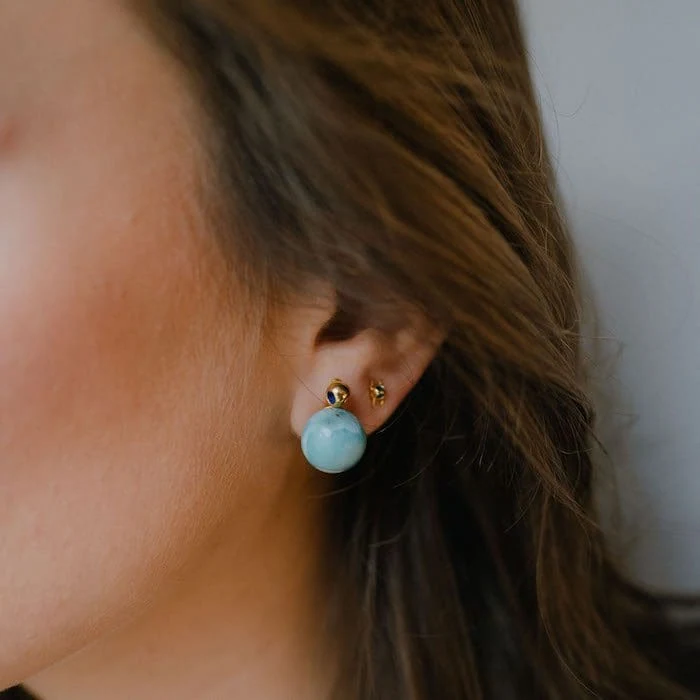 Beautiful Larimar stud earrings with gold accents, perfect for elegant jewelry collection.