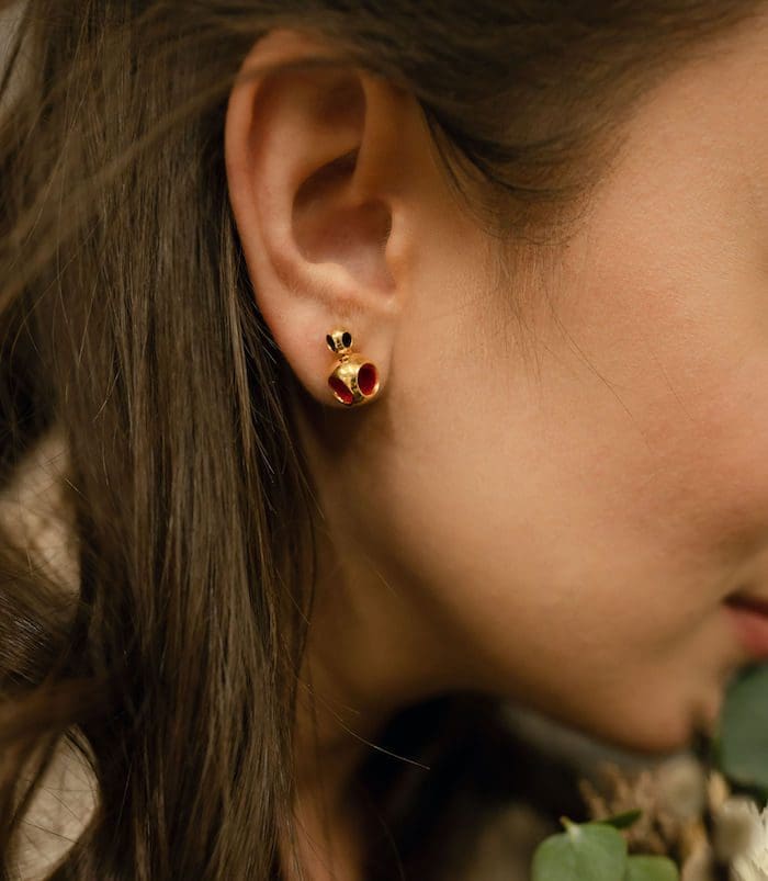 Elegant gold and red miniature stud earrings for women, perfect for subtle style.