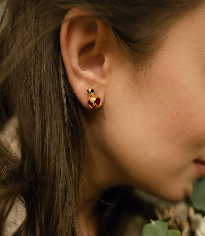 Elegant gold and red miniature stud earrings for women, perfect for subtle style.