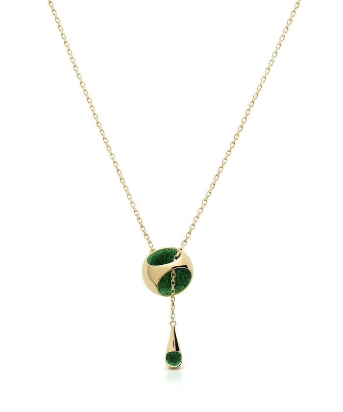 Delicate gold chain necklace featuring a knot design with green accents and a drop pendant. Perfect luxury jewelry piece.