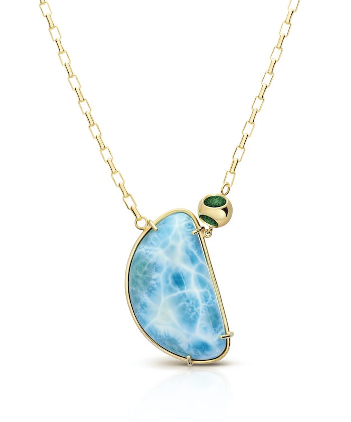 Elegant larimar gemstone pendant on gold chain with green accent bead. Perfect for summer and tropical-inspired jewelry styles.