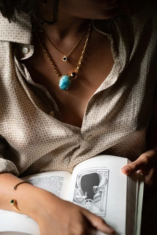 Precious turquoise pendant on gold chain, perfect for stylish jewelry fans.