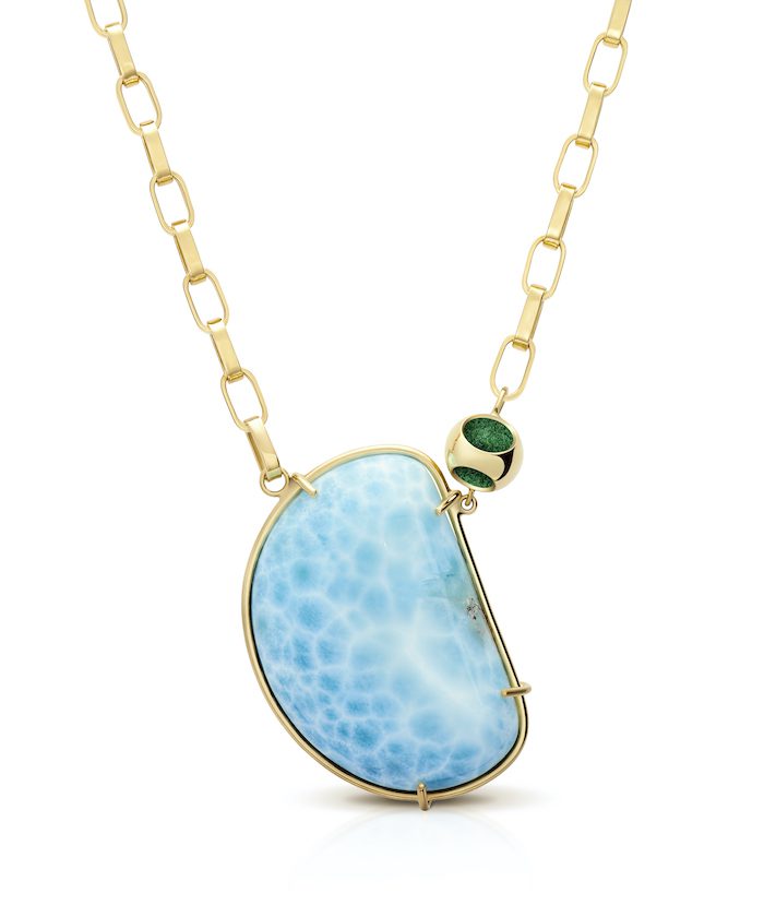 Elegant larimar pendant with gold chain, perfect for stylish jewelry lovers.