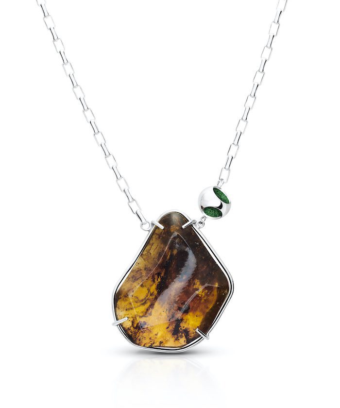 Elegant sterling silver and gemstone jewelry featuring amber and green accents.