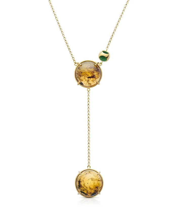 Beautiful gold necklace featuring amber stones with double pendant design. Elegant jewelry for a sophisticated look.
