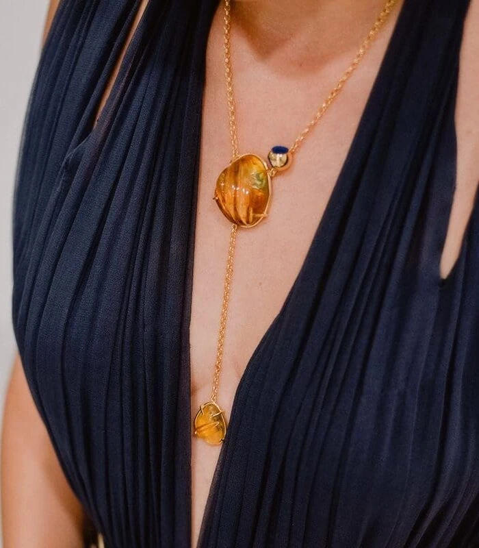 Elegant amber pendant necklace with gold chain, perfect for stylish accessories.
