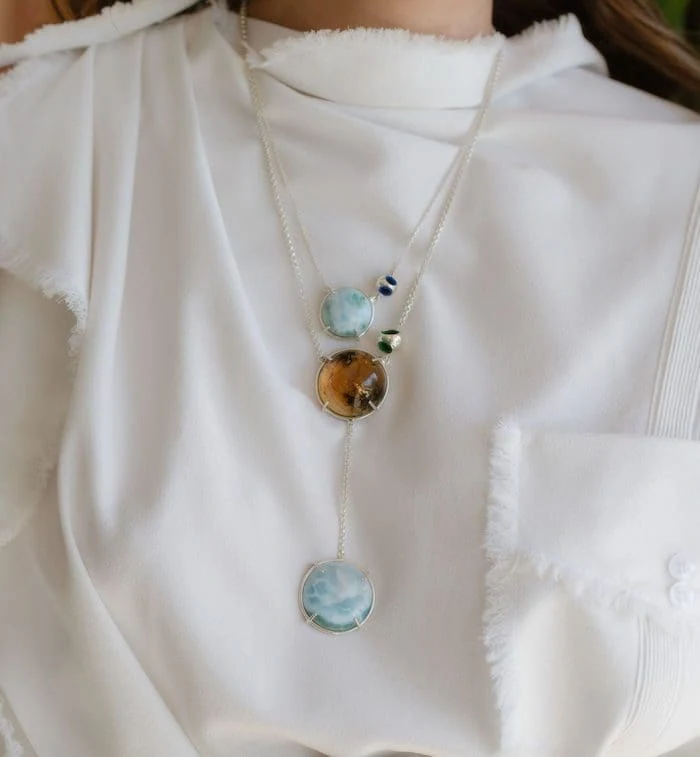 Delicate Larimar and Amber pendant necklaces with silver accents, perfect for jewelry lovers seeking unique gemstone designs.