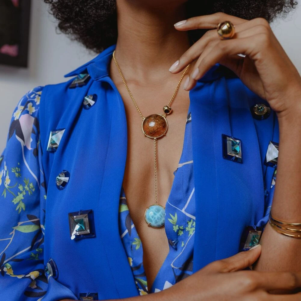 Gold chain necklace with larimar and amber gemstones, perfect for sophisticated style and special occasions.