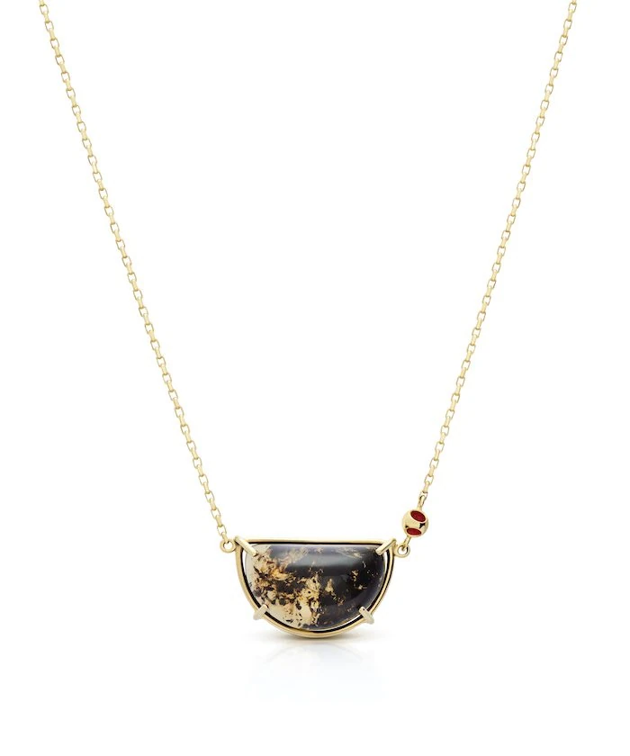 Delicate amber pendant on a sterling silver chain, accented with a red enamel dot. Perfect for sophisticated style.