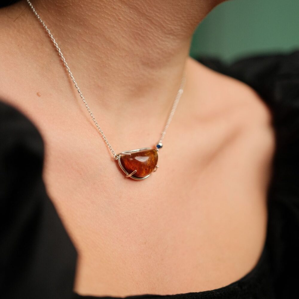 Stunning amber pendant necklace with silver chain, perfect for elegant jewelry style.