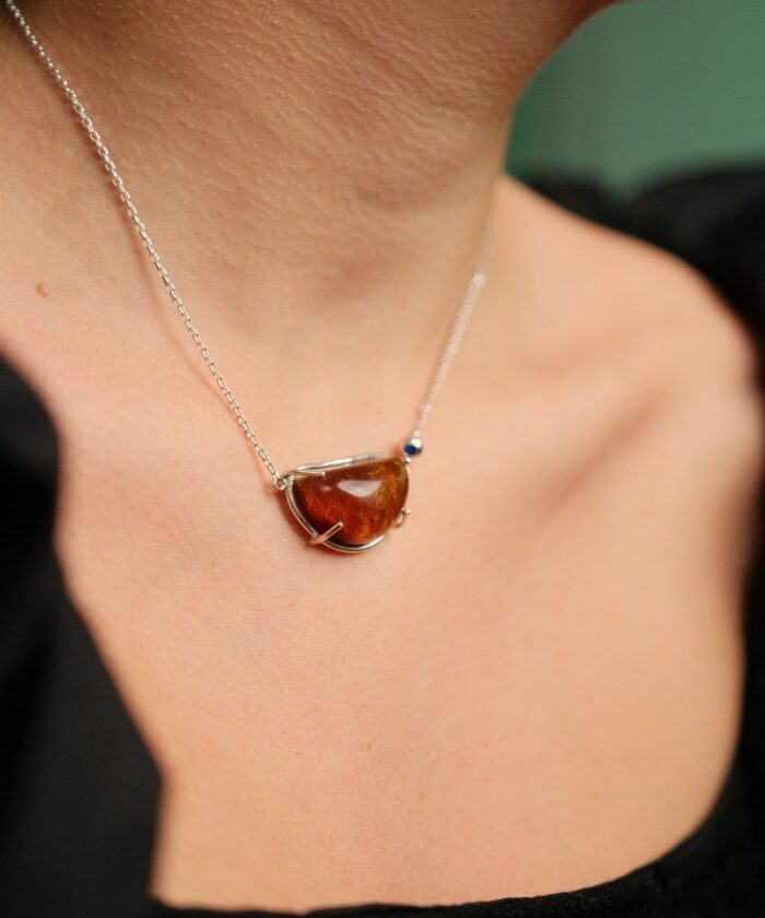 Stunning amber pendant necklace with silver chain, perfect for elegant jewelry style.