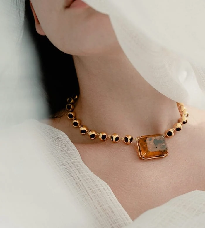 Elegant amber infinity choker with black accents, perfect for luxury jewelry lovers.