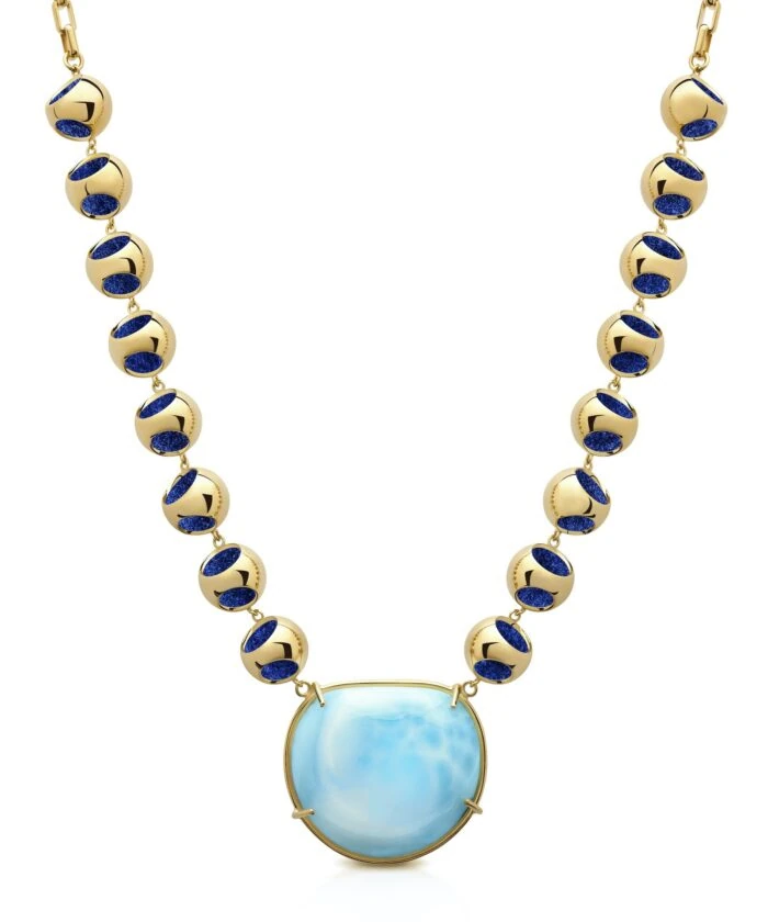 Stunning Larimar choker featuring a large blue gemstone pendant and gold beads with deep blue accents. Perfect for sophisticated jewelry lovers.