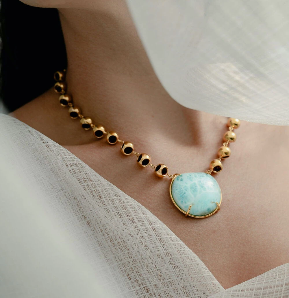 Sterling silver larimar pendant necklace with gold accents, stylish designer jewelry.