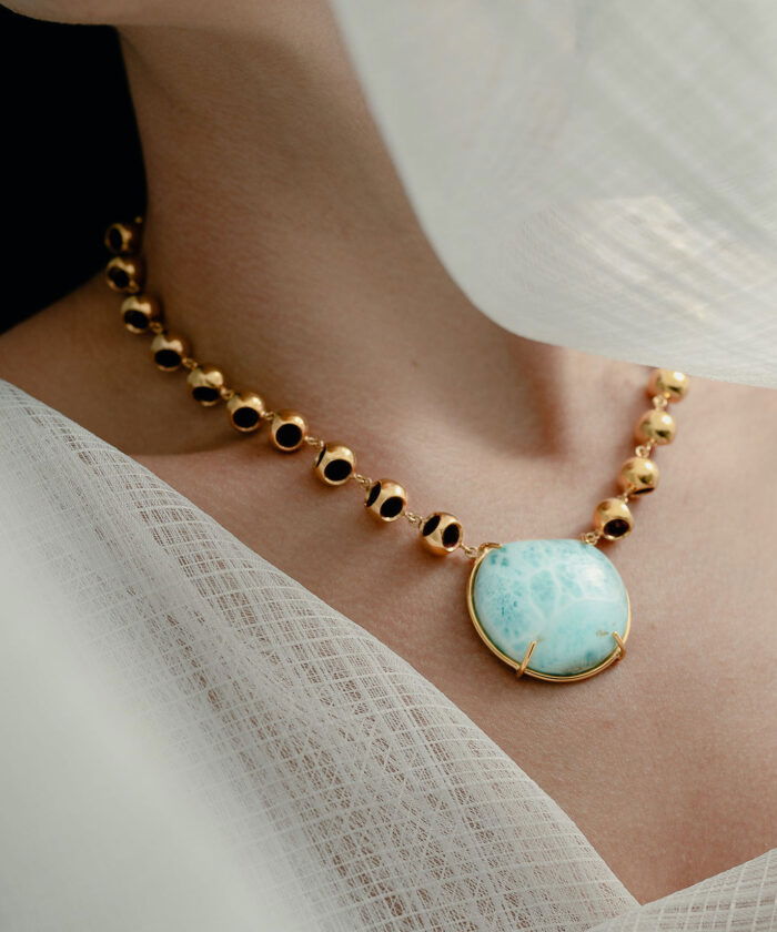 Sterling silver larimar pendant necklace with gold accents, stylish designer jewelry.